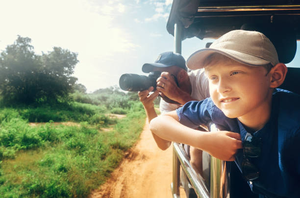 Little expiorer boy with his father safari in the park