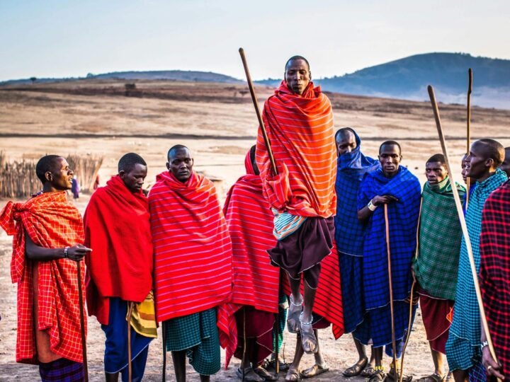 Maasai men performing the adumu jumping dance at a boma on the northern Tanzania plains