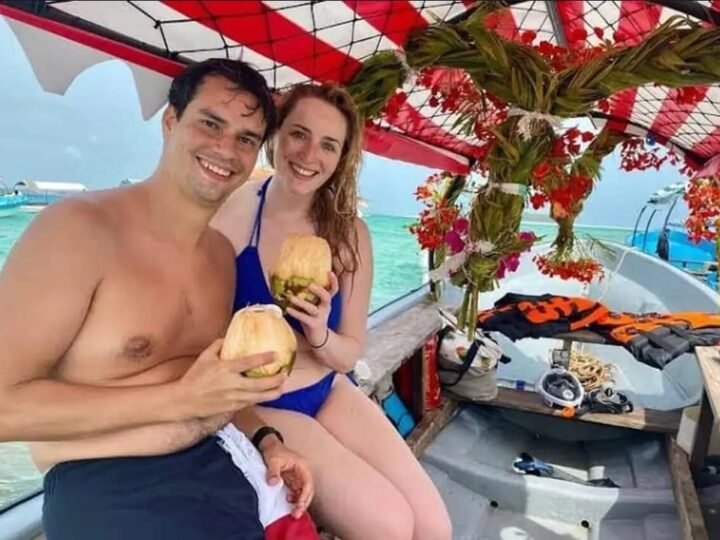 Guests with fresh coconuts on a Mnemba boat trip, Zanzibar